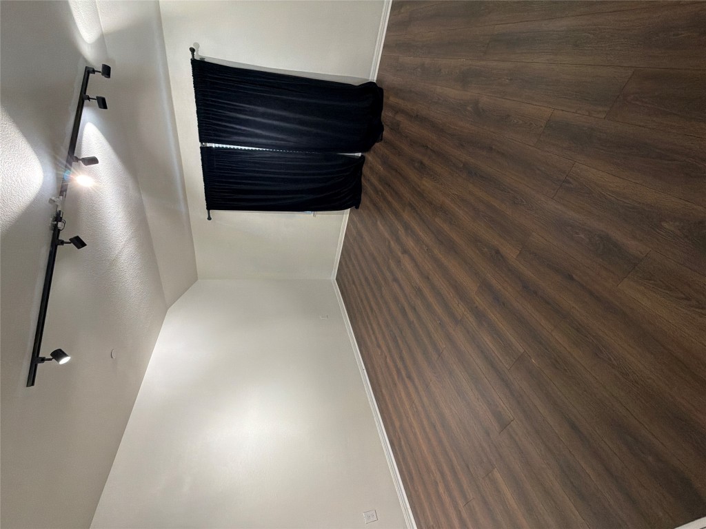 516 East Slaughter Lane, Unit 1404 Austin, TX 78744 - Photo 8 of 17 an empty room with wooden floor and windows