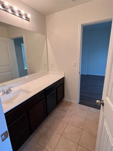 a bathroom with a double vanity sink a and mirror