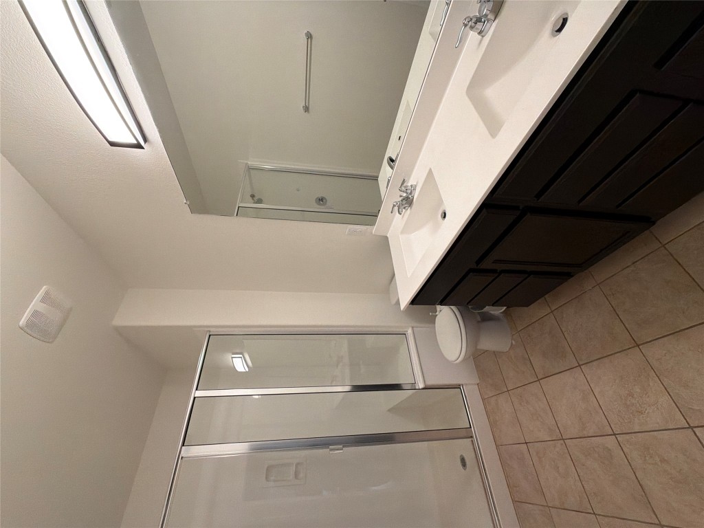516 East Slaughter Lane, Unit 1404 Austin, TX 78744 - Photo 10 of 17 a spacious bathroom with a double vanity sink toilet and a shower