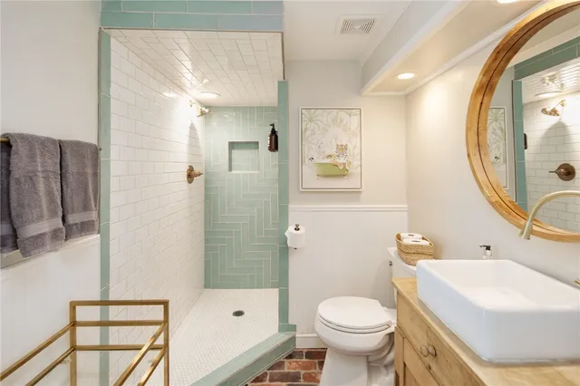 a bathroom with a sink toilet and shower