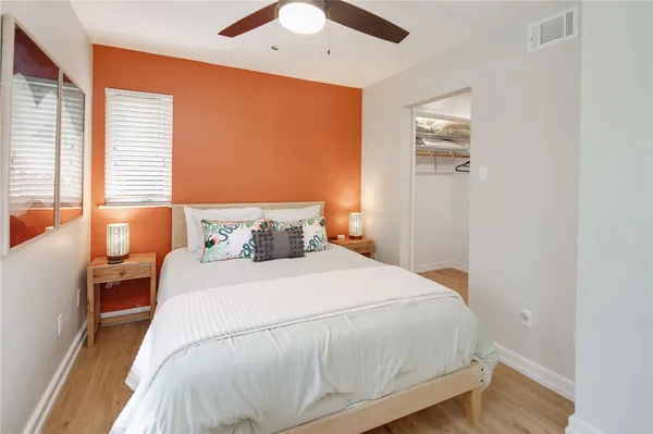 a bedroom with a bed and wooden floor