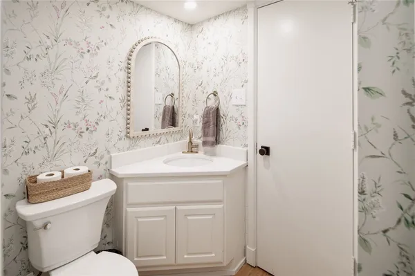 a bathroom with a toilet sink and mirror