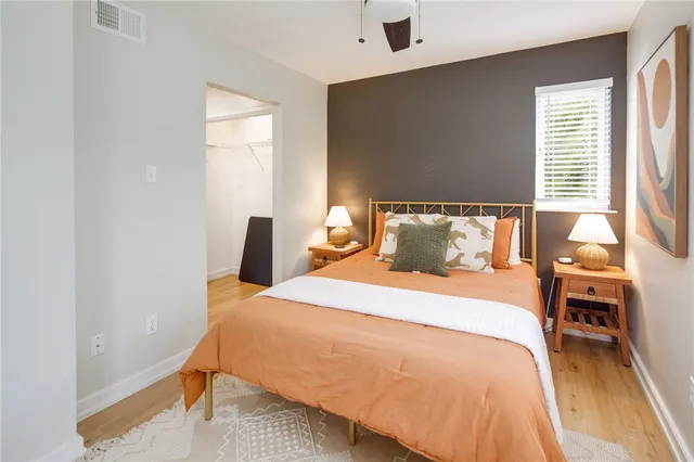 a bedroom with a bed and wooden floor