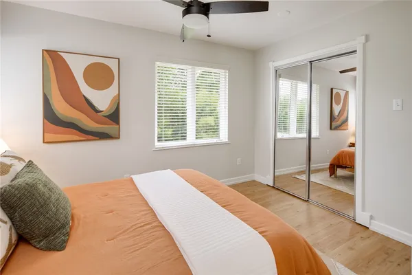 a bedroom with a bed and a painting on the wall