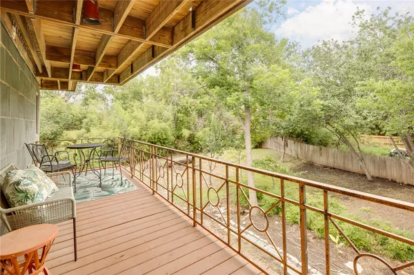 a view of a balcony with table and chairs