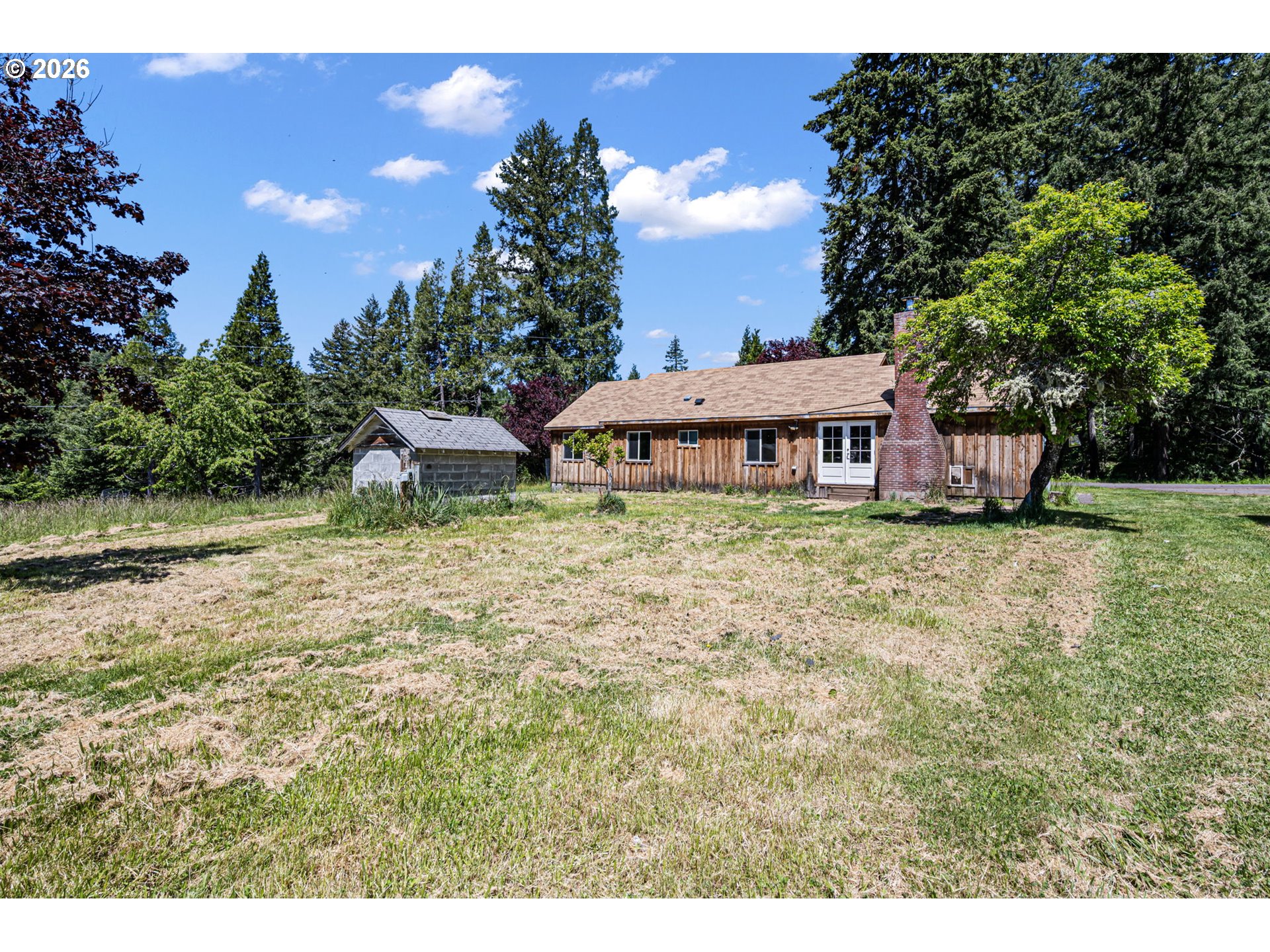 77521 Brock Road Oakridge, OR 97463 - Photo 42 of 48 a view of a house with a yard porch and sitting area