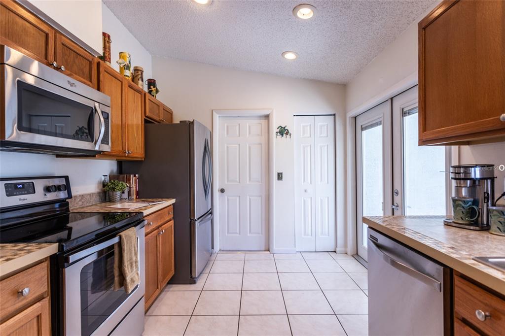22 Westfield Lane Palm Coast, FL 32164 - Photo 16 of 47 a kitchen with stainless steel appliances granite countertop a stove a sink and a microwave