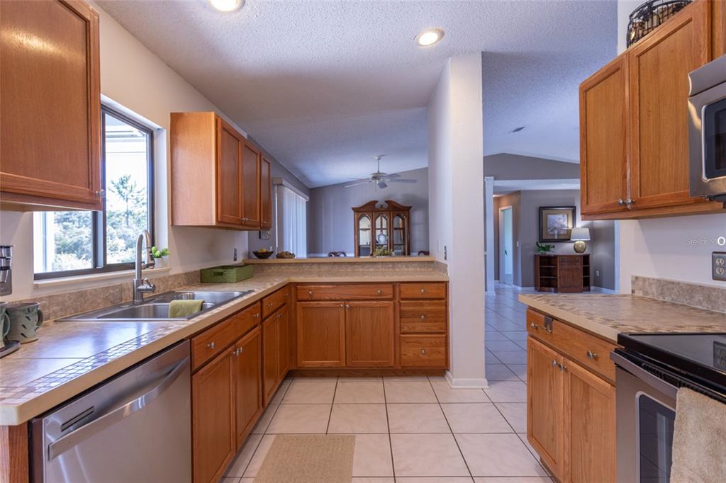 22 Westfield Lane Palm Coast, FL 32164 - Photo 17 of 47 a kitchen with stainless steel appliances granite countertop a sink and dishwasher a stove top oven with wooden floor
