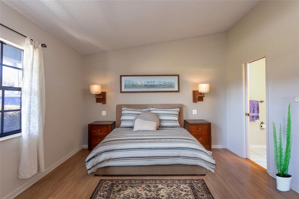 22 Westfield Lane Palm Coast, FL 32164 - Photo 27 of 47 a bedroom with a bed and wooden floor