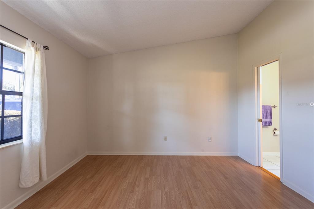 22 Westfield Lane Palm Coast, FL 32164 - Photo 28 of 47 an empty room with wooden floor and windows
