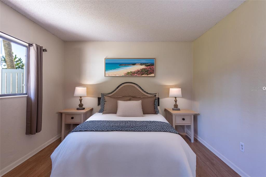 22 Westfield Lane Palm Coast, FL 32164 - Photo 30 of 47 a bedroom with a bed and a night stand