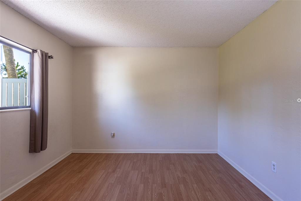 22 Westfield Lane Palm Coast, FL 32164 - Photo 31 of 47 an empty room with wooden floor and windows