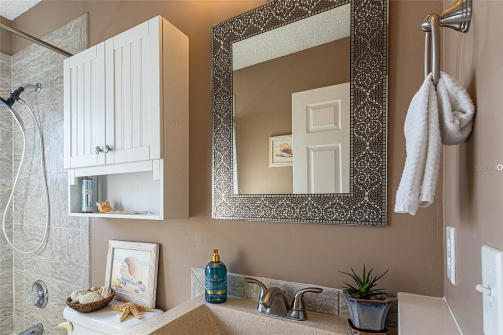 22 Westfield Lane Palm Coast, FL 32164 - Photo 35 of 47 a bathroom with a sink a mirror and a shower