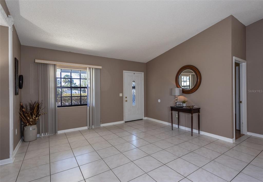 22 Westfield Lane Palm Coast, FL 32164 - Photo 10 of 47 an empty room with mirror and windows