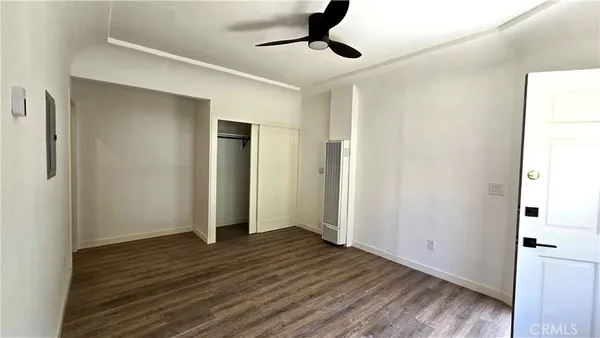 a view of an empty room with wooden floor