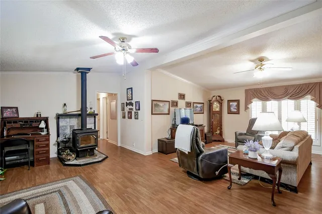 a view of a livingroom with furniture and a ceiling fan