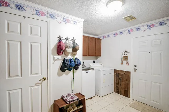 a kitchen with a sink cabinets and utility room