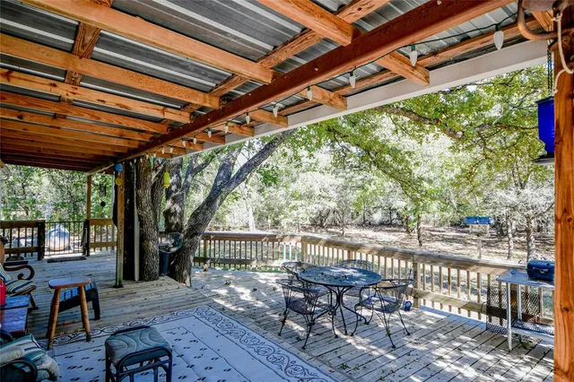 a patio with glass top table and chairs