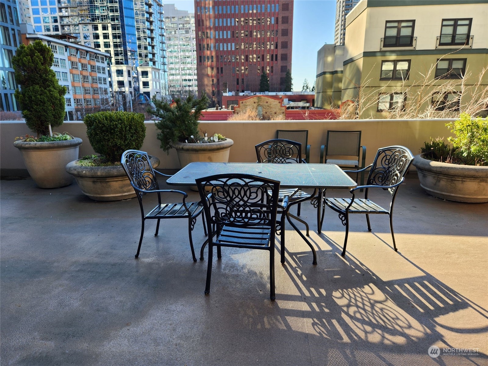 2100 3rd Avenue, Unit 2106 Seattle, WA 98121 - Photo 11 of 25 a view of a patio with a table and chairs