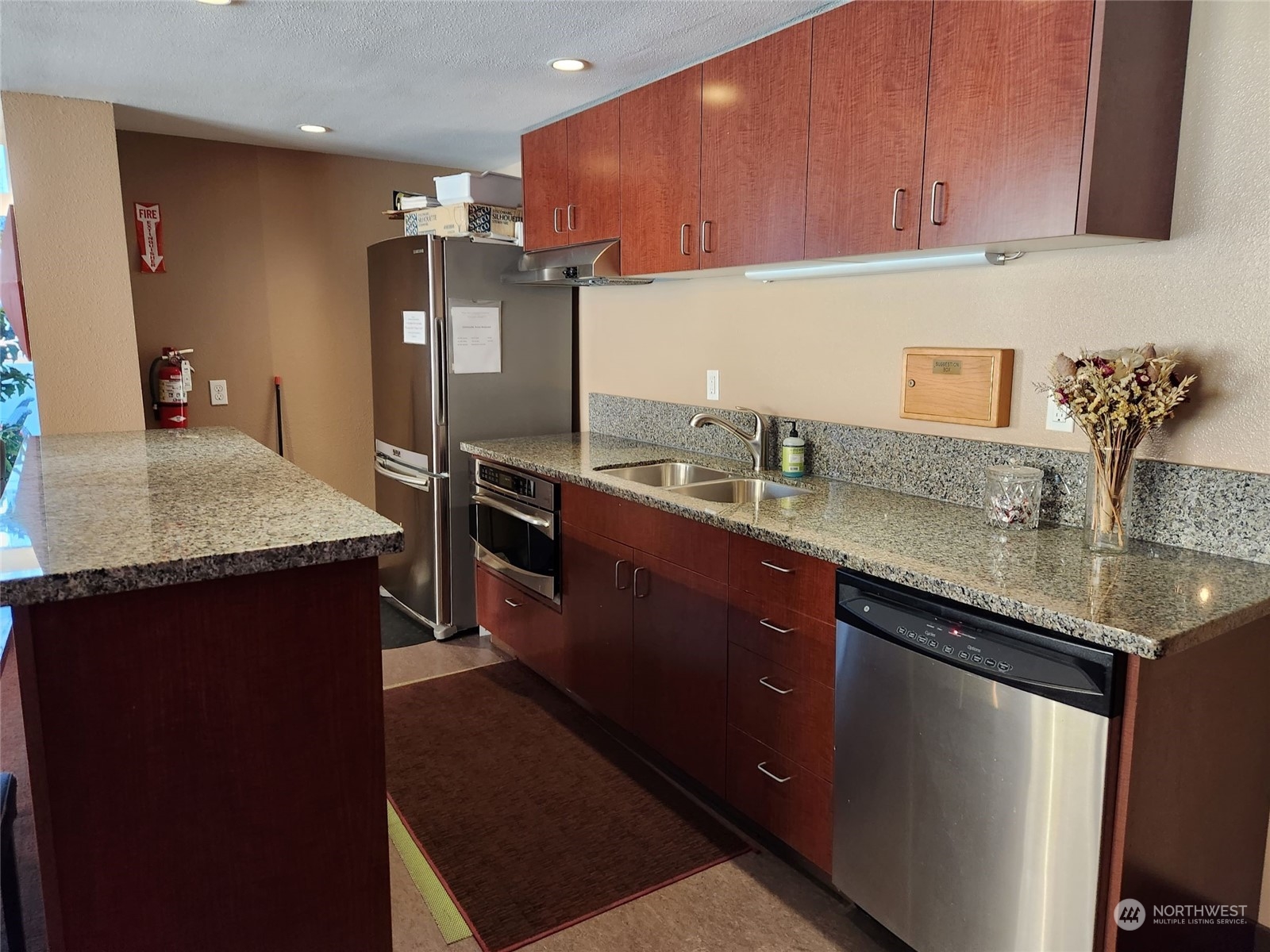 2100 3rd Avenue, Unit 2106 Seattle, WA 98121 - Photo 17 of 25 a kitchen with stainless steel appliances granite countertop a sink stove and refrigerator