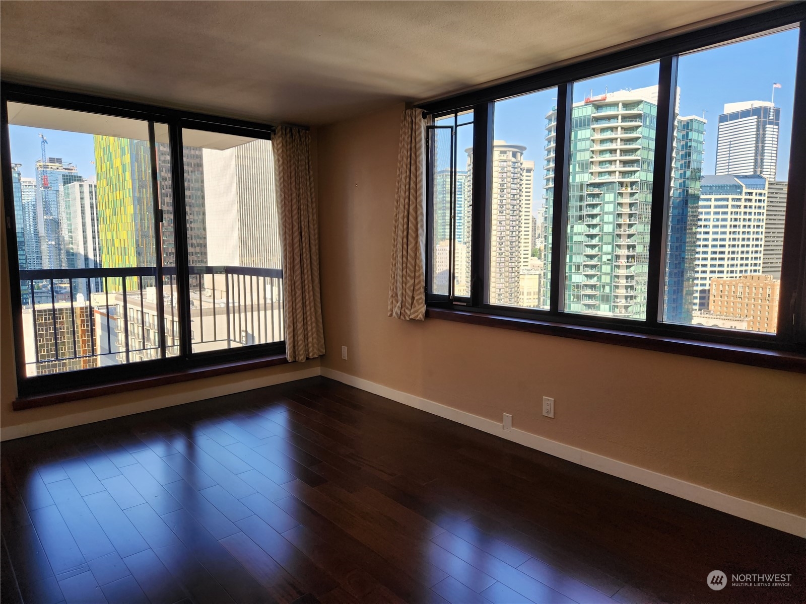 2100 3rd Avenue, Unit 2106 Seattle, WA 98121 - Photo 2 of 25 a view of a room with wooden floor and windows