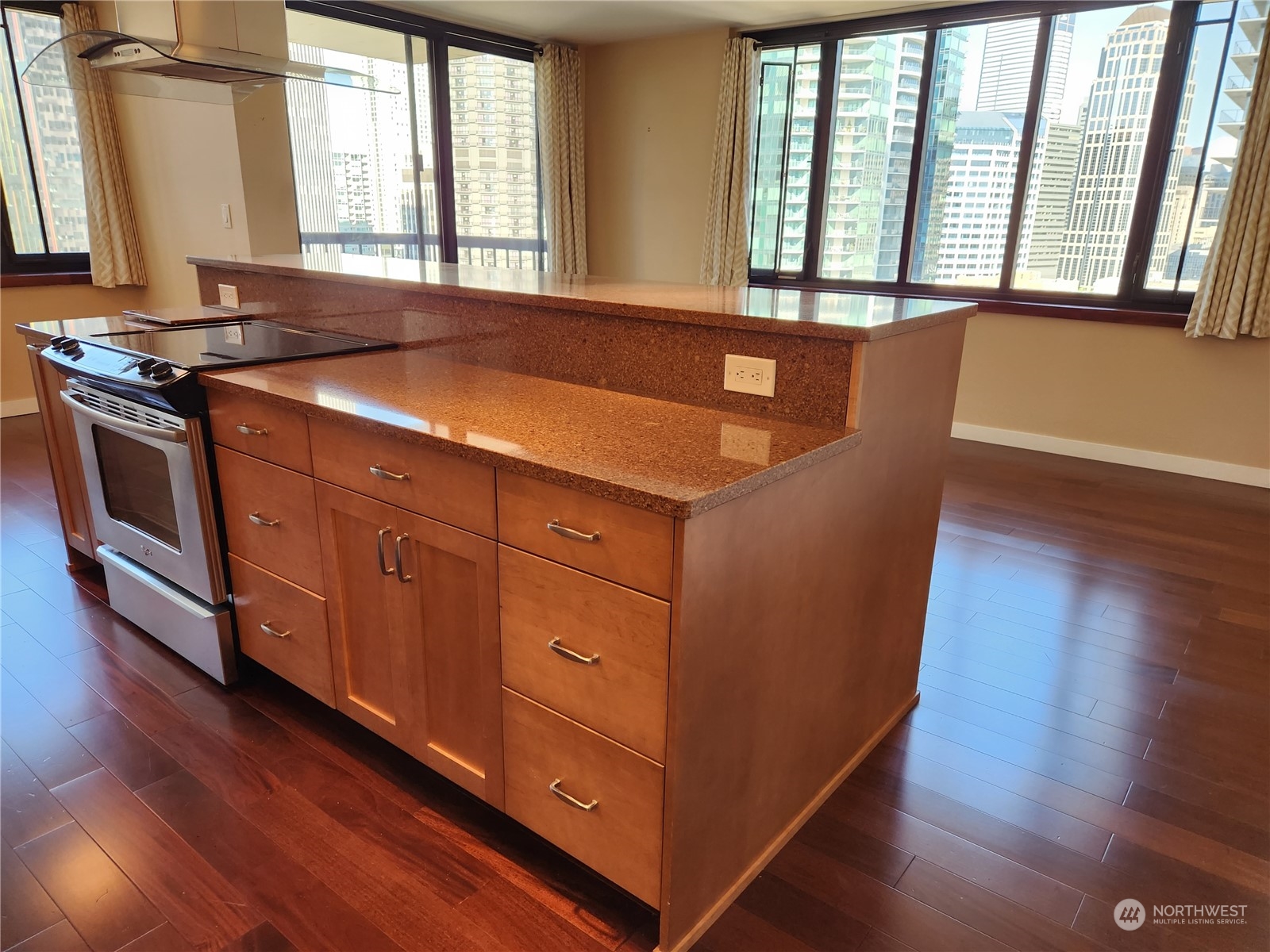 2100 3rd Avenue, Unit 2106 Seattle, WA 98121 - Photo 4 of 25 a kitchen with stainless steel appliances granite countertop a stove a sink and a large window