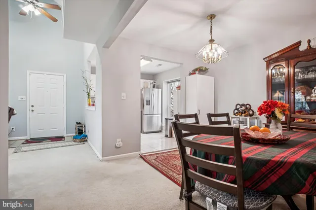 a view of a dining room with furniture and chandelier