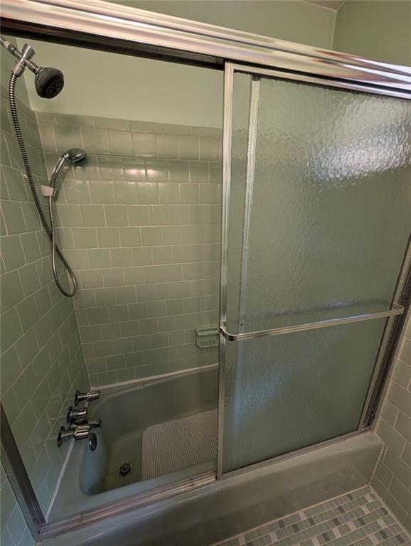 109 7th Street Carrollton, GA 30117 - Photo 12 of 19 a bathroom with a glass shower door