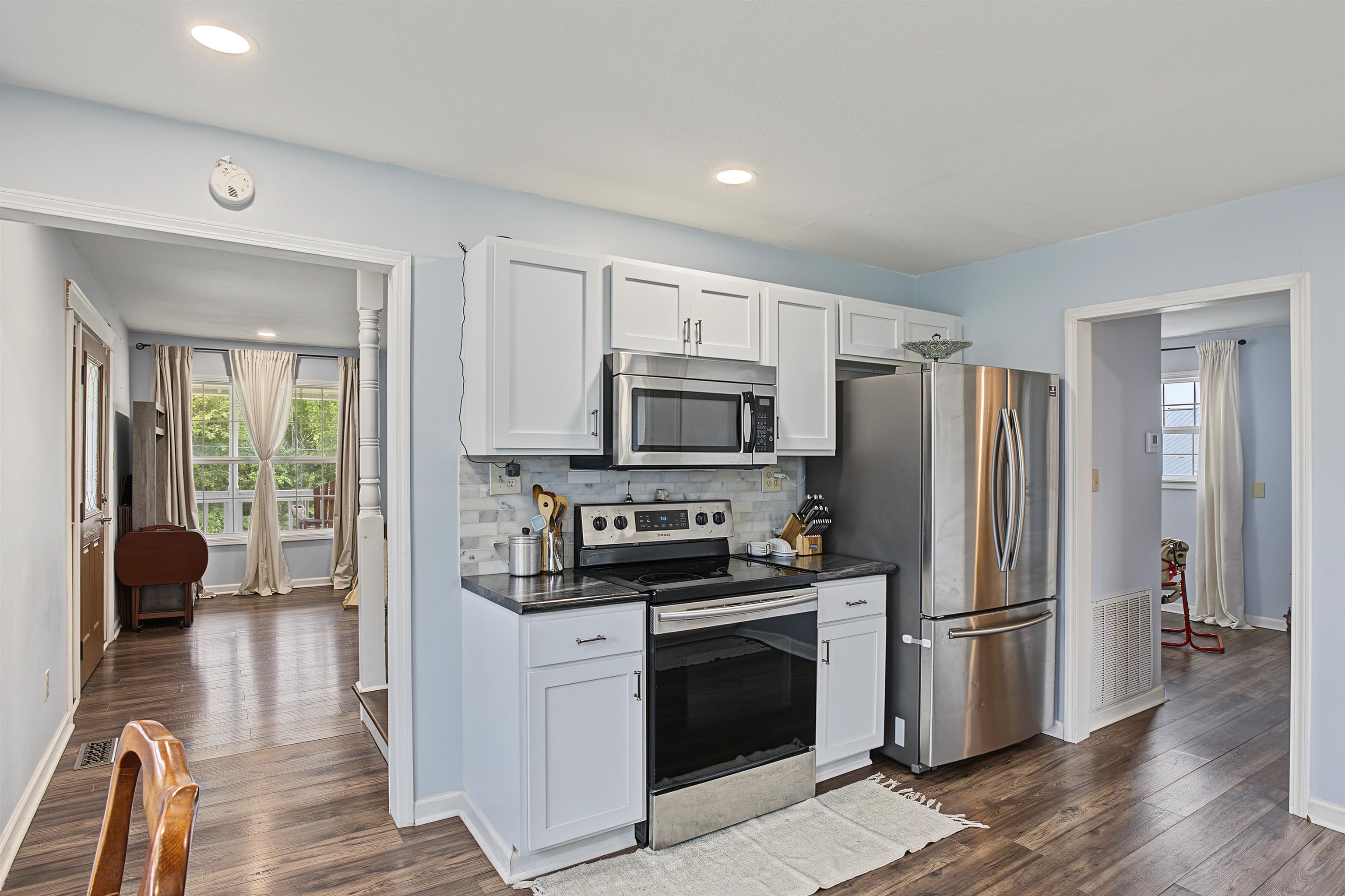 246 Cherryville Road Bells, TN 38006 - Photo 17 of 31 Kitchen featuring white cabinetry, stainless steel appliances, dark countertops, and a tiled backsplash