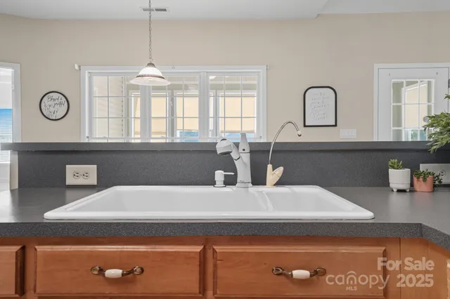 a kitchen with granite countertop a stove top oven microwave and cabinets