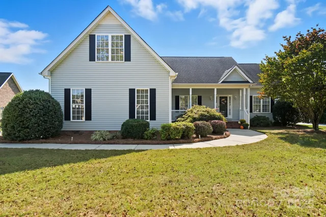 a front view of a house with swimming pool and porch