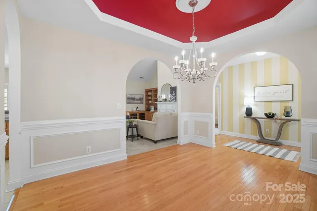 a living room with furniture fireplace and potted plants