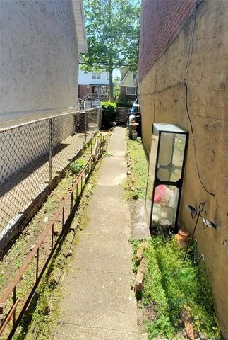 a street view with tall buildings and cars parked on road