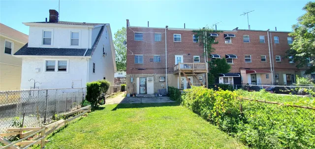 a front view of a house with a yard table and chairs