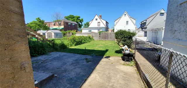 a view of a garden with large trees