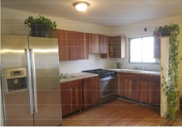 a kitchen with a sink a counter and stainless steel appliances