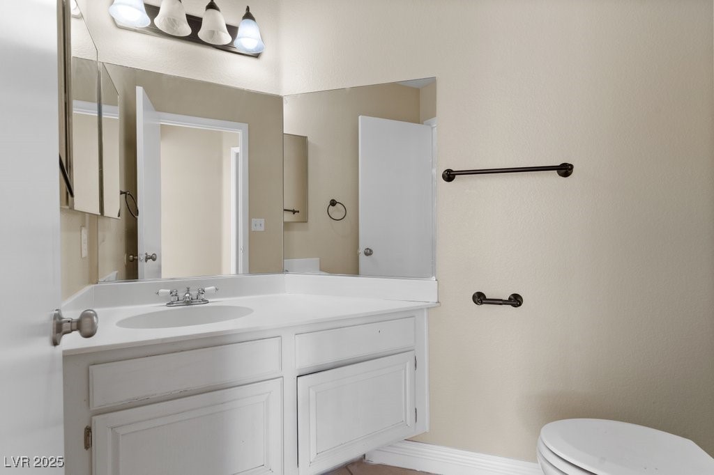 5309 West Camino Del Rancho Las Vegas, NV 89130 - Photo 16 of 41 Half bathroom with vanity and toilet