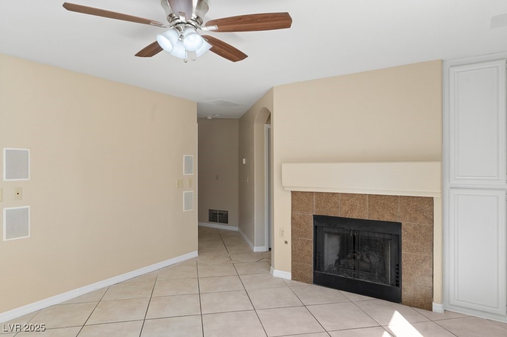 5309 West Camino Del Rancho Las Vegas, NV 89130 - Photo 17 of 41 Unfurnished living room featuring light tile patterned floors, a tile fireplace, and ceiling fan