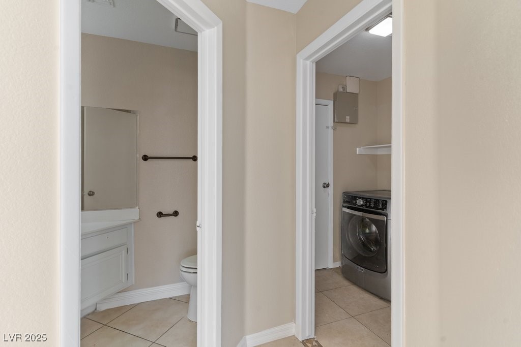 5309 West Camino Del Rancho Las Vegas, NV 89130 - Photo 20 of 41 Bathroom with light tile patterned floors, washer / clothes dryer, and vanity