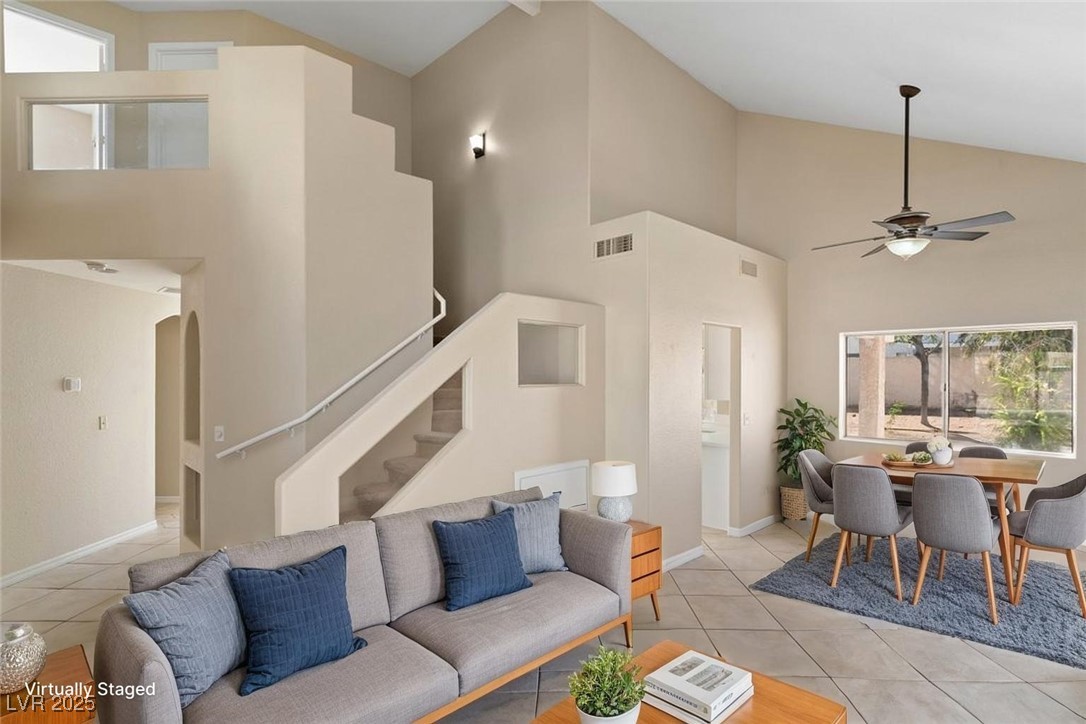 5309 West Camino Del Rancho Las Vegas, NV 89130 - Photo 2 of 41 Living room with high vaulted ceiling, light tile patterned floors, and ceiling fan