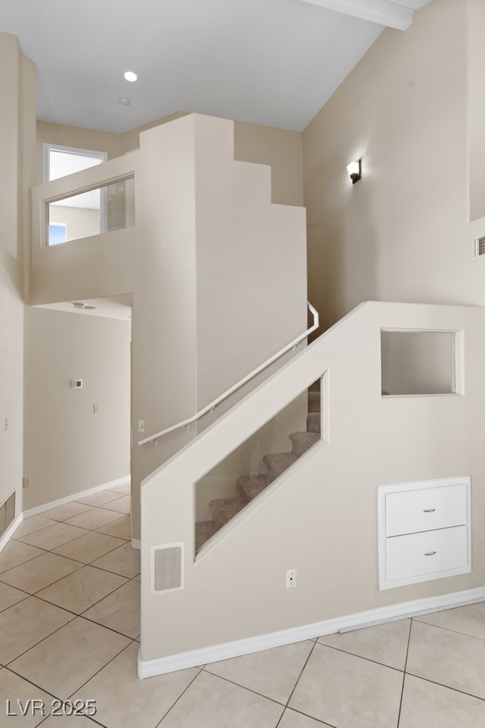 5309 West Camino Del Rancho Las Vegas, NV 89130 - Photo 22 of 41 Stairs with tile patterned flooring and a towering ceiling