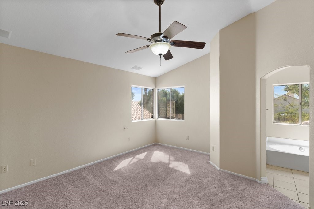 5309 West Camino Del Rancho Las Vegas, NV 89130 - Photo 25 of 41 Unfurnished bedroom with vaulted ceiling, ceiling fan, carpet, and ensuite bath