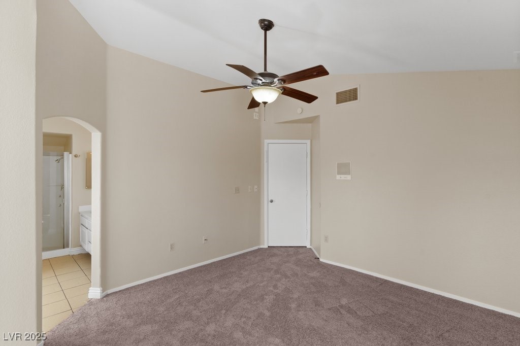 5309 West Camino Del Rancho Las Vegas, NV 89130 - Photo 26 of 41 Unfurnished bedroom featuring high vaulted ceiling, carpet floors, arched walkways, ensuite bath, and a ceiling fan