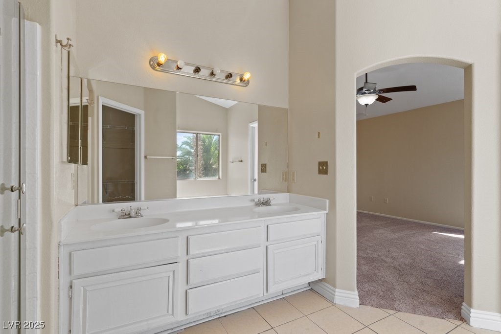 5309 West Camino Del Rancho Las Vegas, NV 89130 - Photo 28 of 41 Full bathroom with light tile patterned floors, double vanity, and ceiling fan