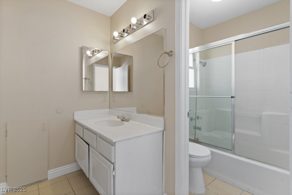 5309 West Camino Del Rancho Las Vegas, NV 89130 - Photo 31 of 41 Bathroom featuring light tile patterned flooring, bath / shower combo with glass door, and vanity