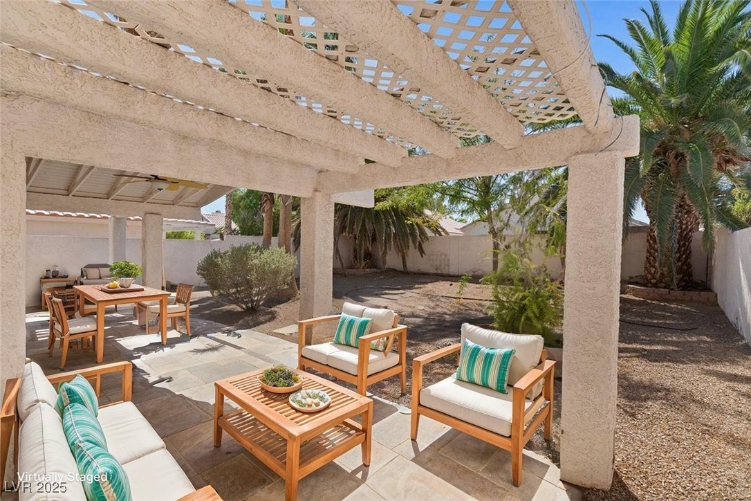 5309 West Camino Del Rancho Las Vegas, NV 89130 - Photo 35 of 41 Fenced backyard featuring an outdoor hangout area, a patio, a pergola, and outdoor dining space