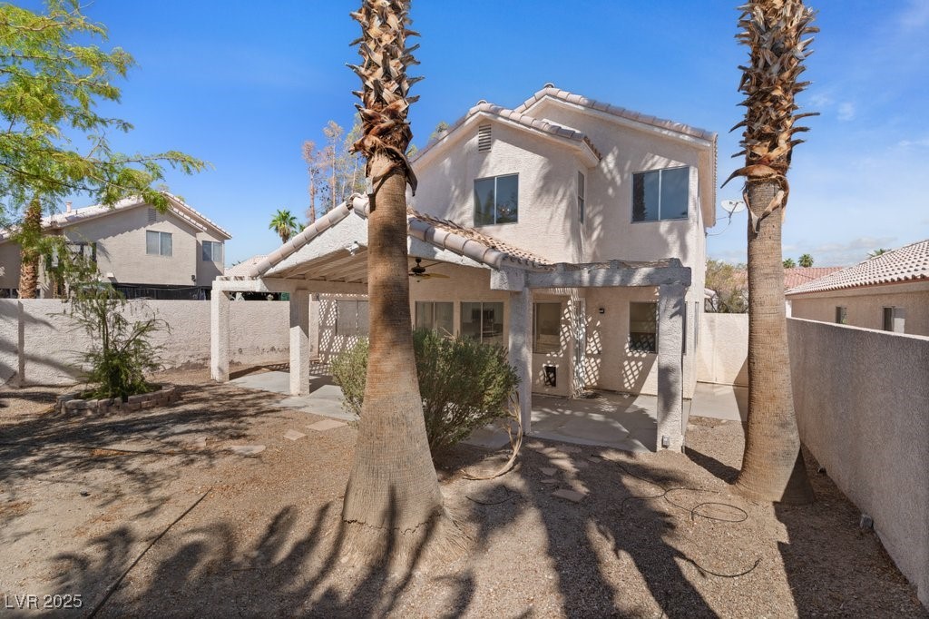 5309 West Camino Del Rancho Las Vegas, NV 89130 - Photo 39 of 41 Rear view of property with a fenced backyard, a ceiling fan, a pergola, stucco siding, and a patio area