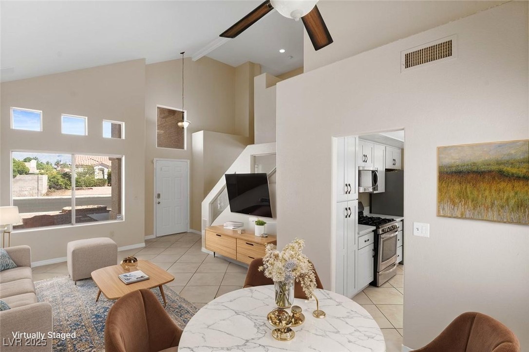 5309 West Camino Del Rancho Las Vegas, NV 89130 - Photo 4 of 41 Living area featuring high vaulted ceiling, light tile patterned floors, ceiling fan, and beamed ceiling