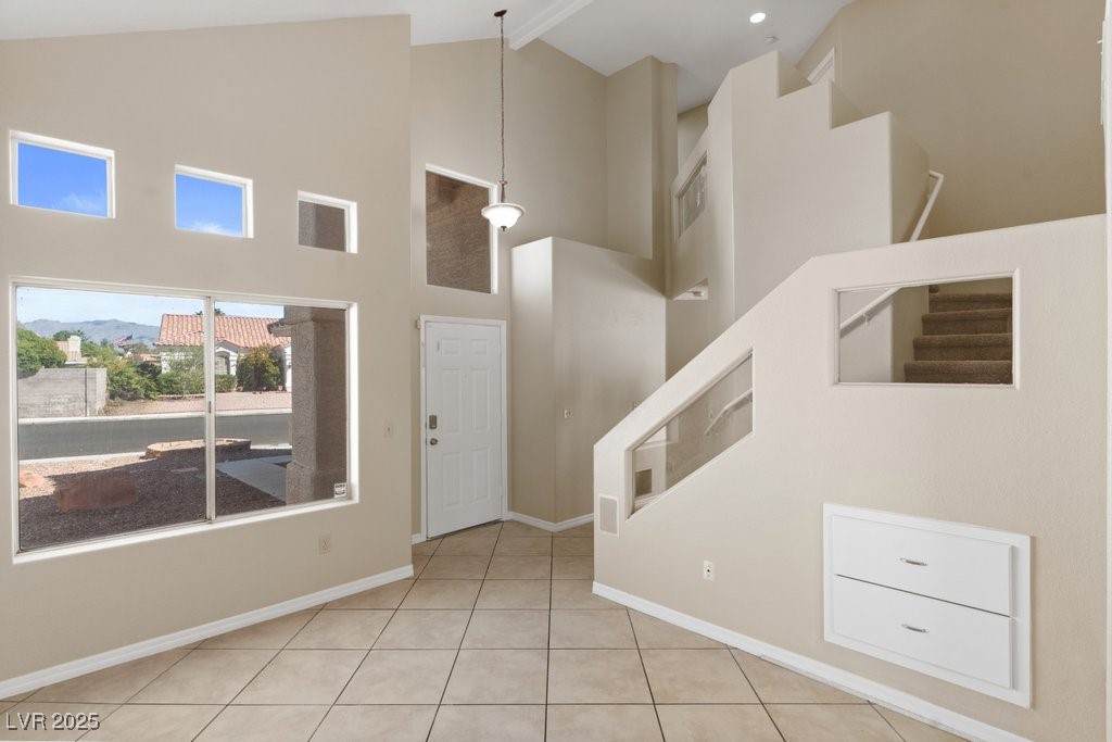 5309 West Camino Del Rancho Las Vegas, NV 89130 - Photo 6 of 41 Foyer entrance featuring high vaulted ceiling, stairs, beam ceiling, and light tile patterned flooring