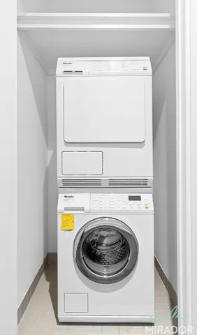 a view of a kitchen with a sink and dishwasher with wooden floor
